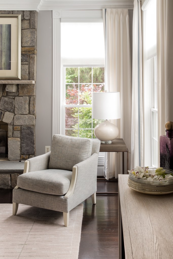 Bright living room with large windows, classic furniture, and stylish accents.