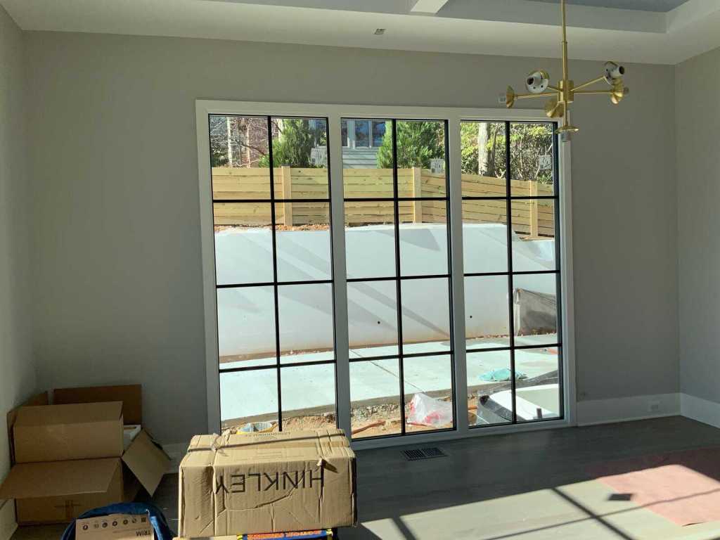 Beautiful interior view of a spacious living room with large glass doors bringing in natural light.