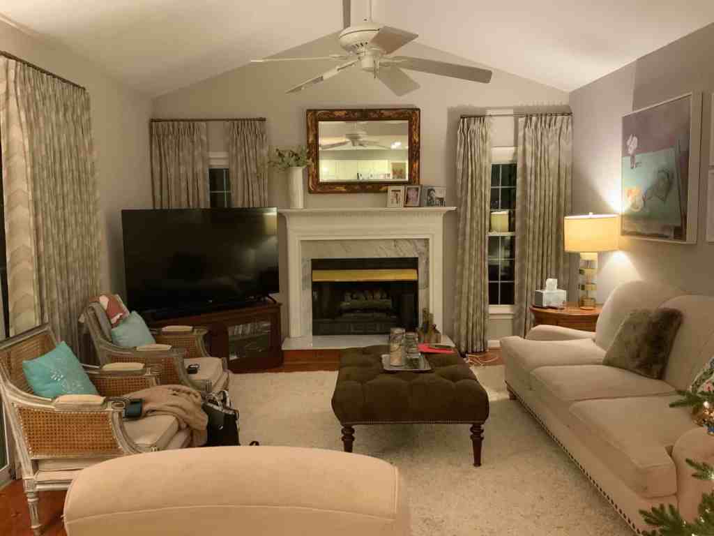 Indoor living space featuring a fireplace, TV, cozy seating, and decorative curtains.
