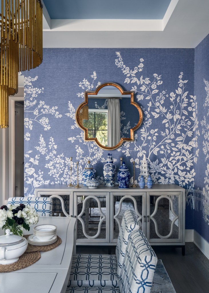 Crisp off-white furniture balances the richness of the muraled walls.