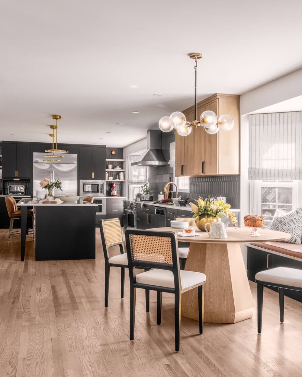 Bright and airy kitchen featuring a modern black and wood design with window seating.