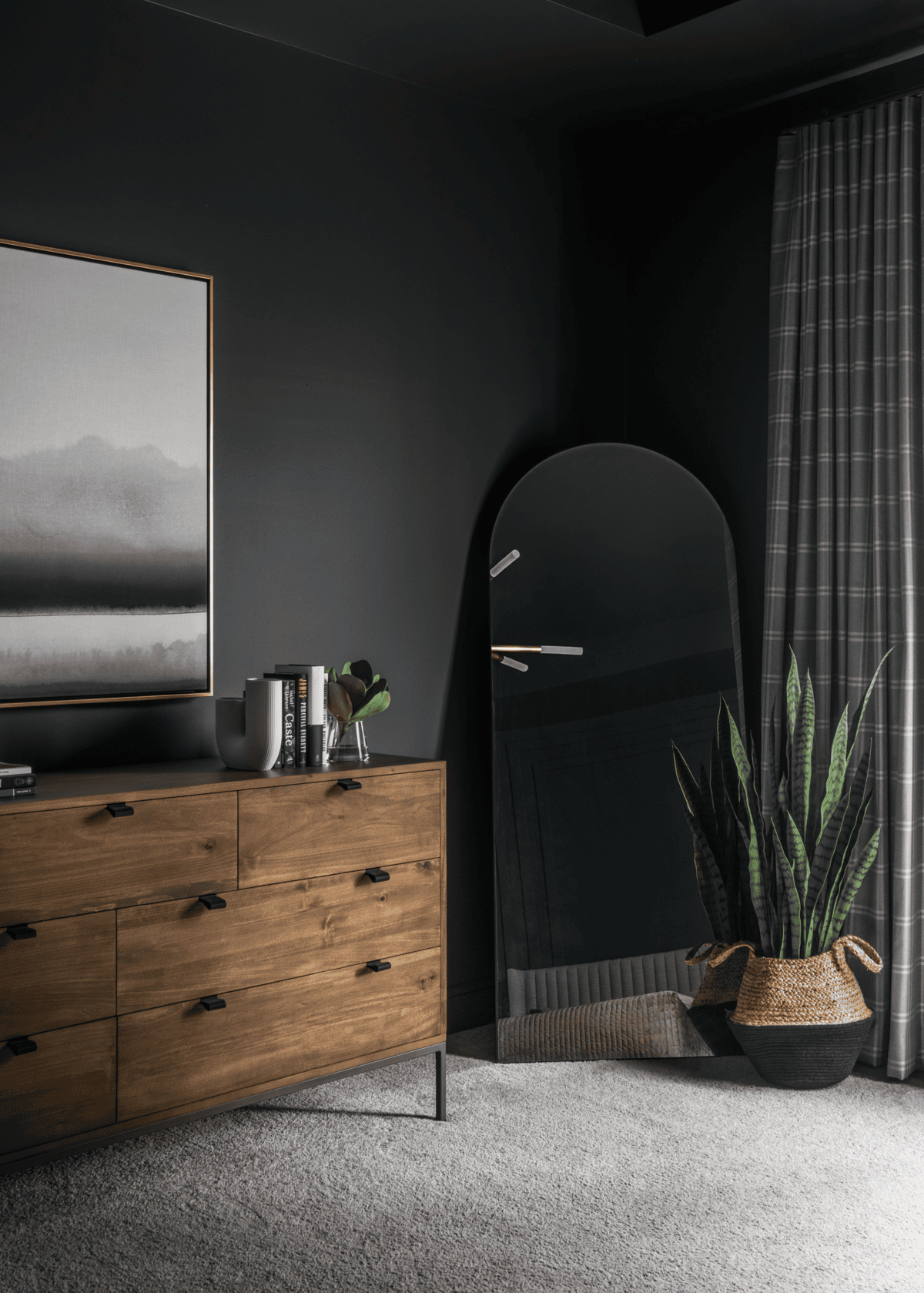 Modern room with wooden furniture, mirror, and indoor plants.