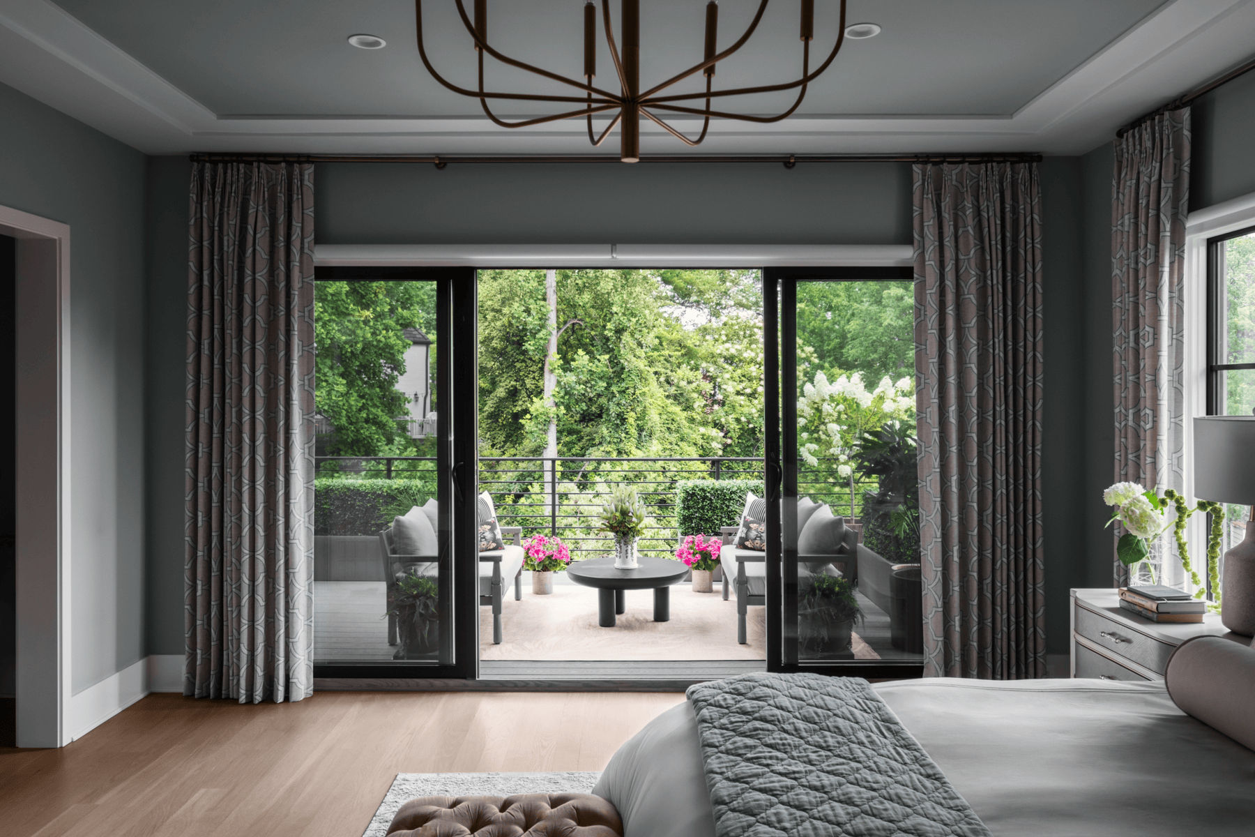 Spacious living room featuring large glass sliding doors leading to a beautiful outdoor patio with g.