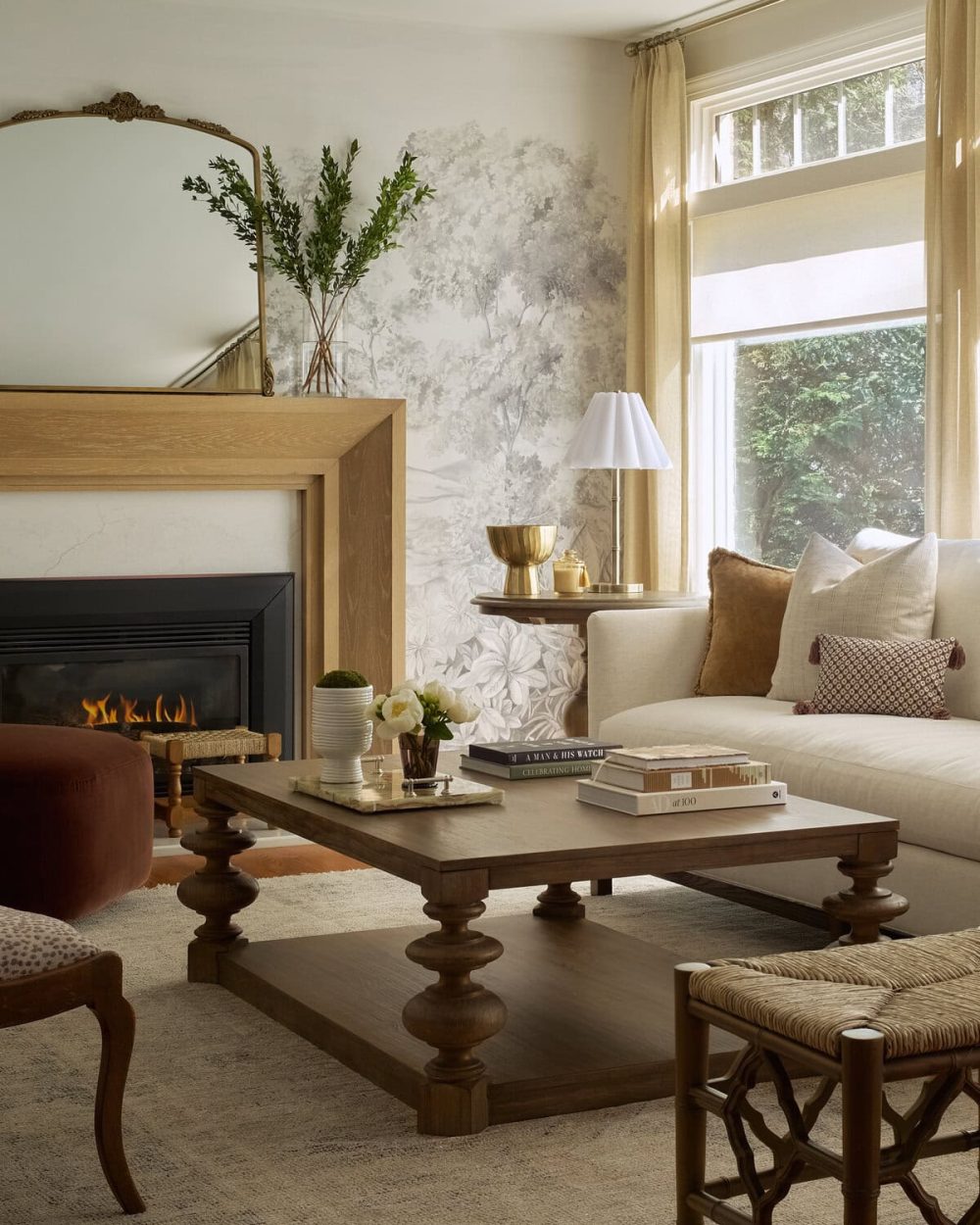 Elegant designer living room with subtle mural walls and warm and inviting furnishings.