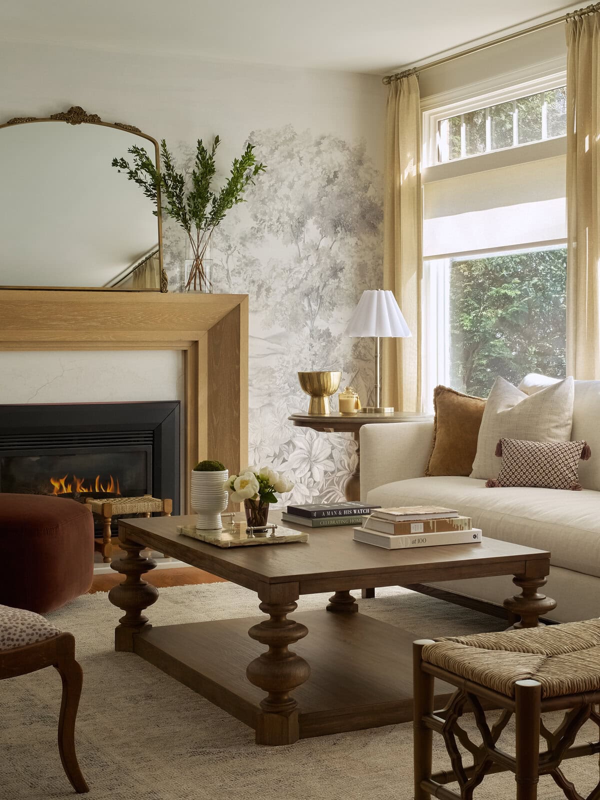 Elegant designer living room with subtle mural walls and warm and inviting furnishings.